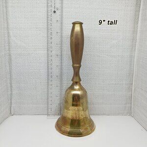 Brass bell 9" tall. Looks like a school bell and I think the handle is metal?